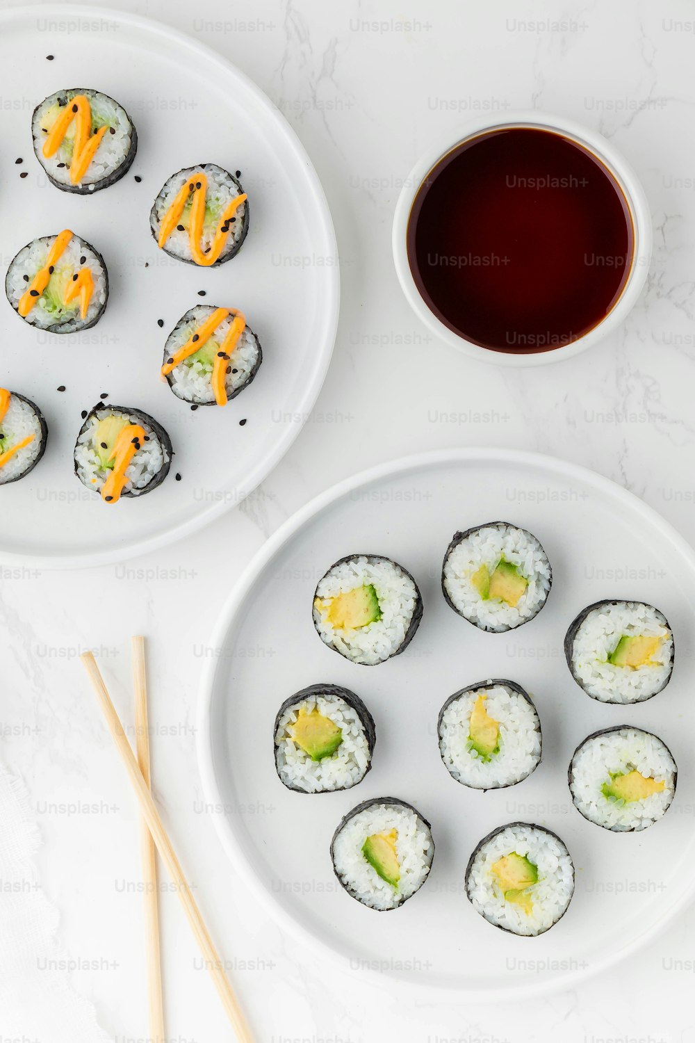 a white plate topped with sushi next to a cup of tea