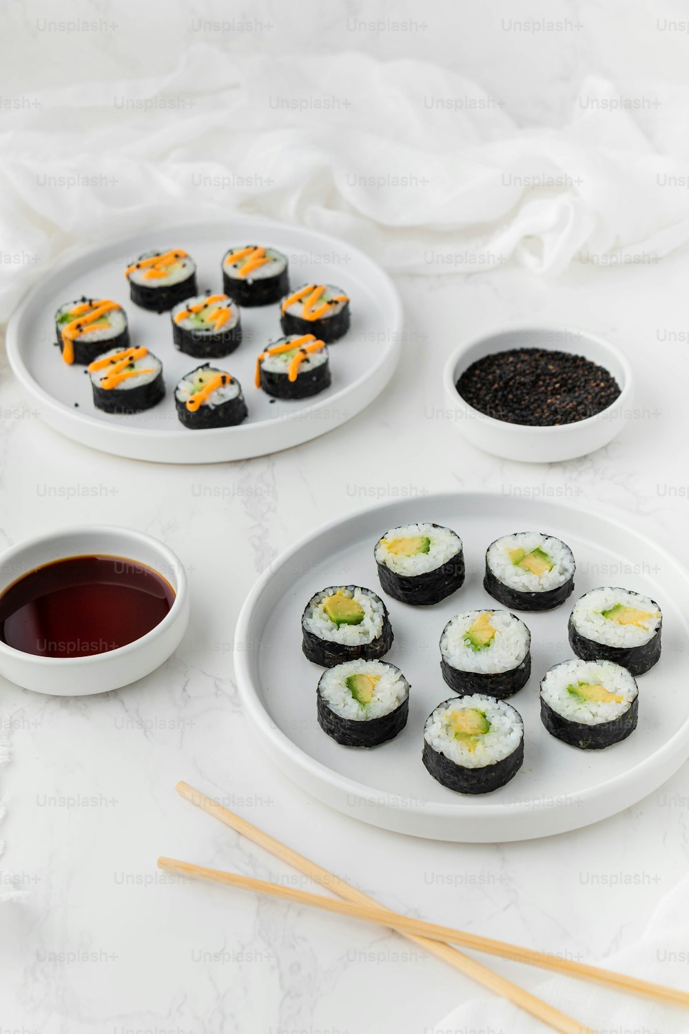 um prato de sushi com pauzinhos ao lado