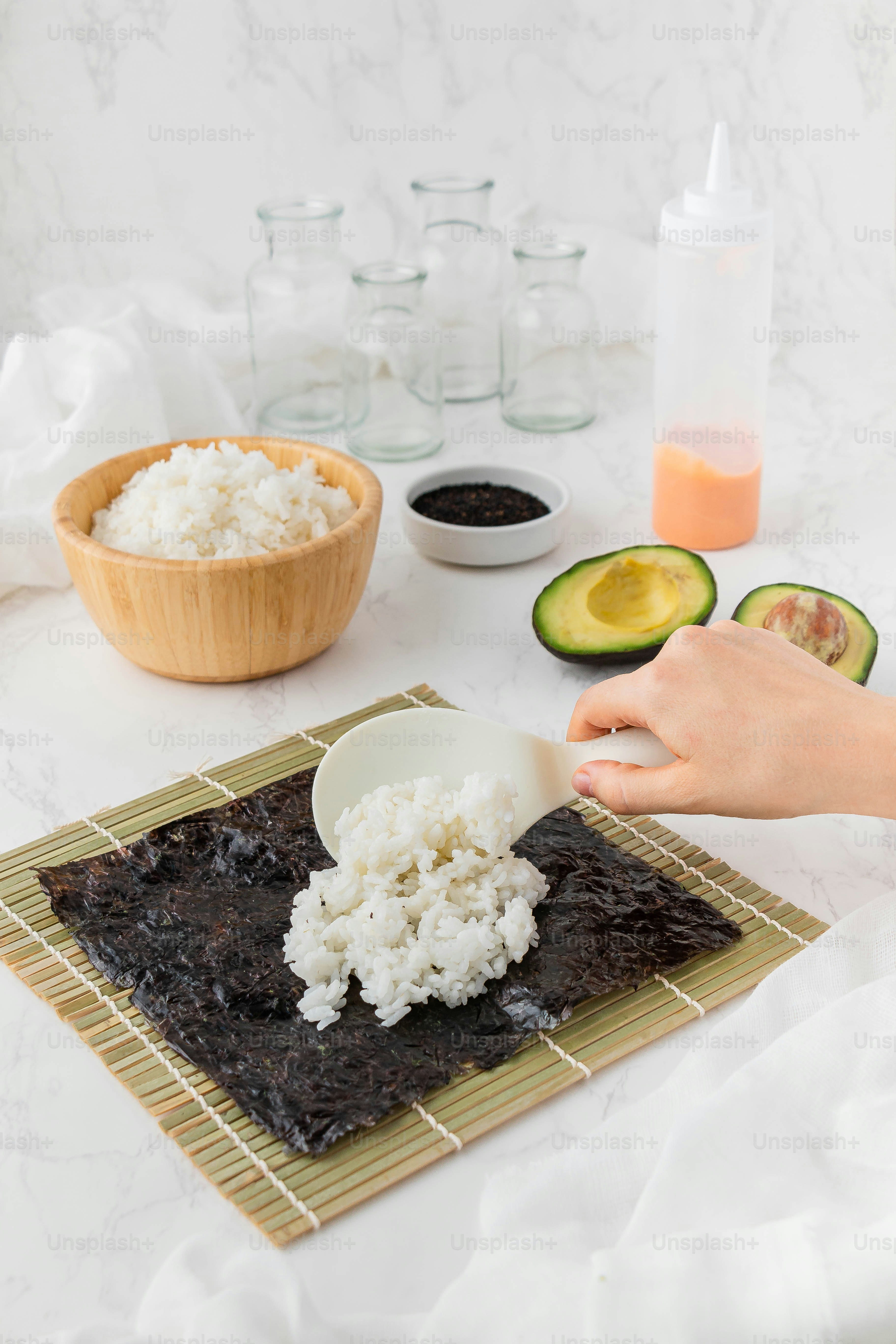 a person scooping rice out of a bowl