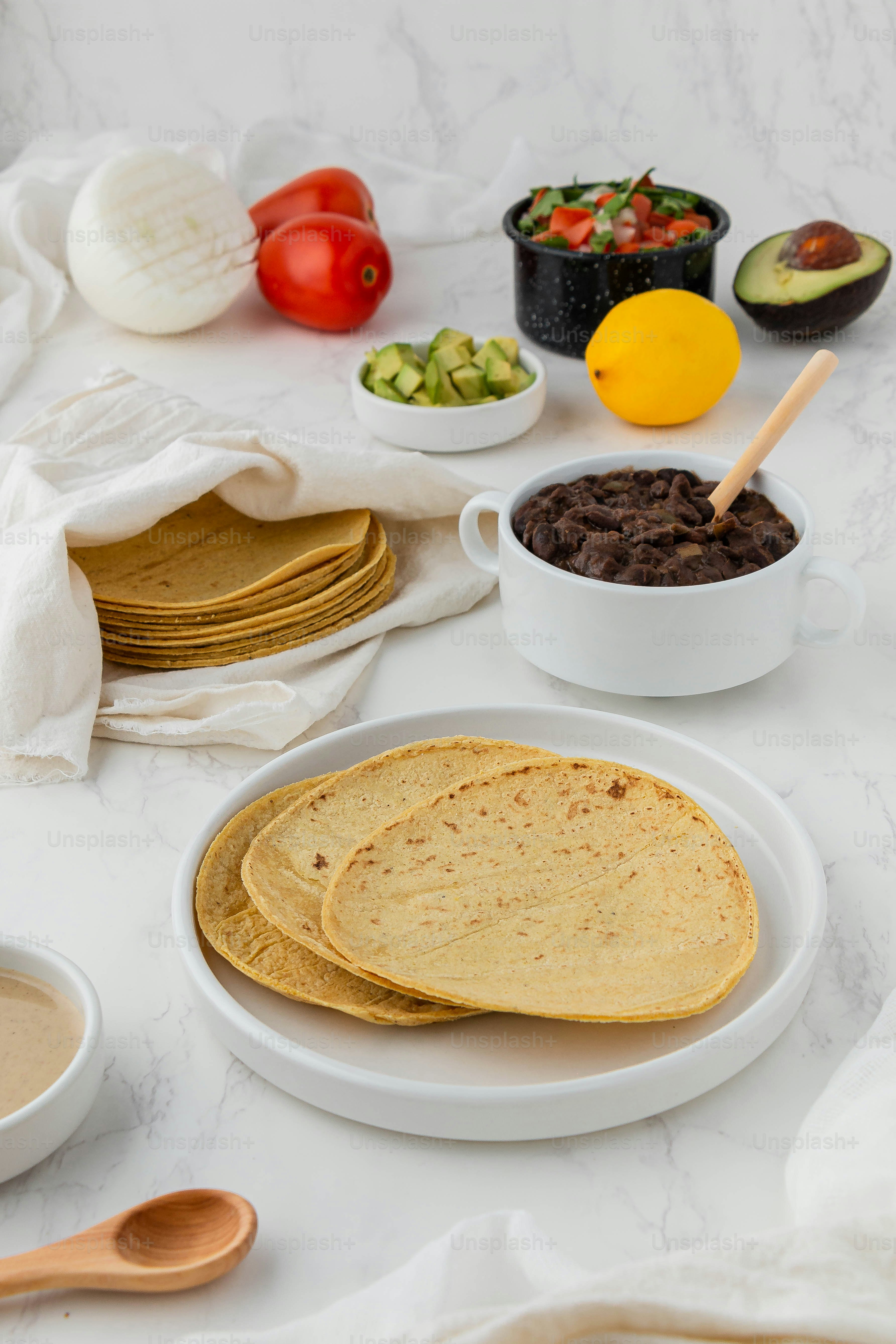 a table topped with plates and bowls filled with food