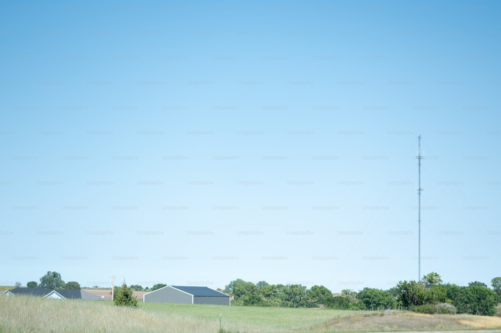 a field with a telephone pole in the distance