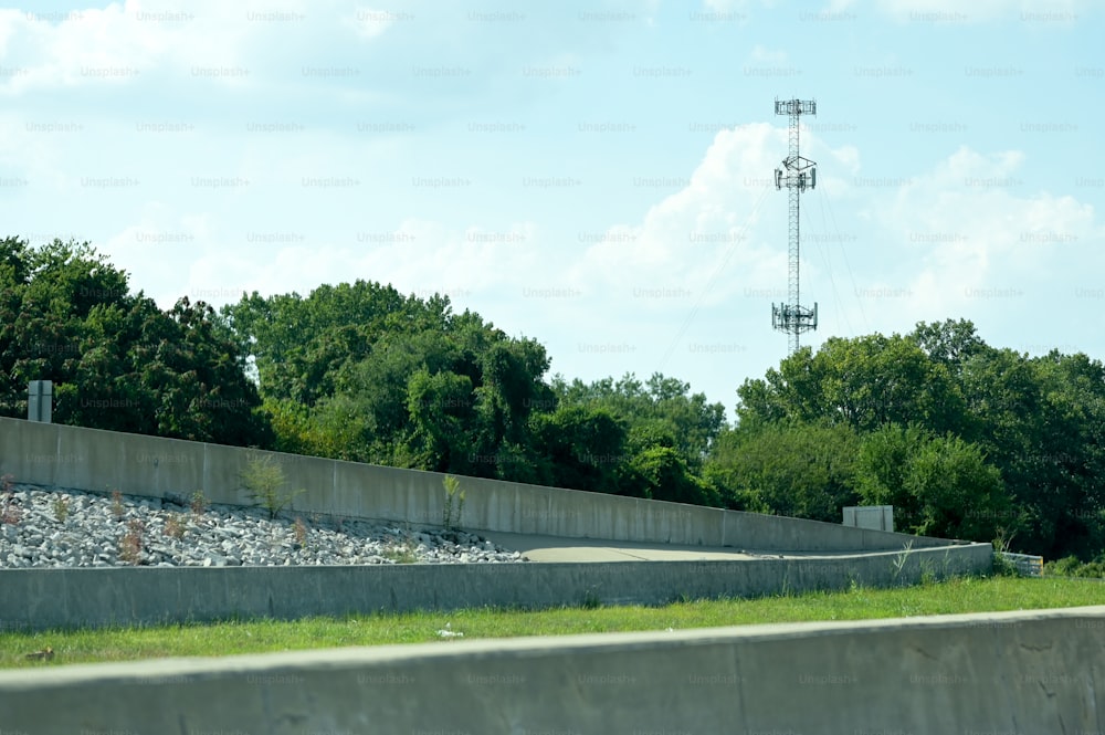 a view of a cell phone tower from the side of a road