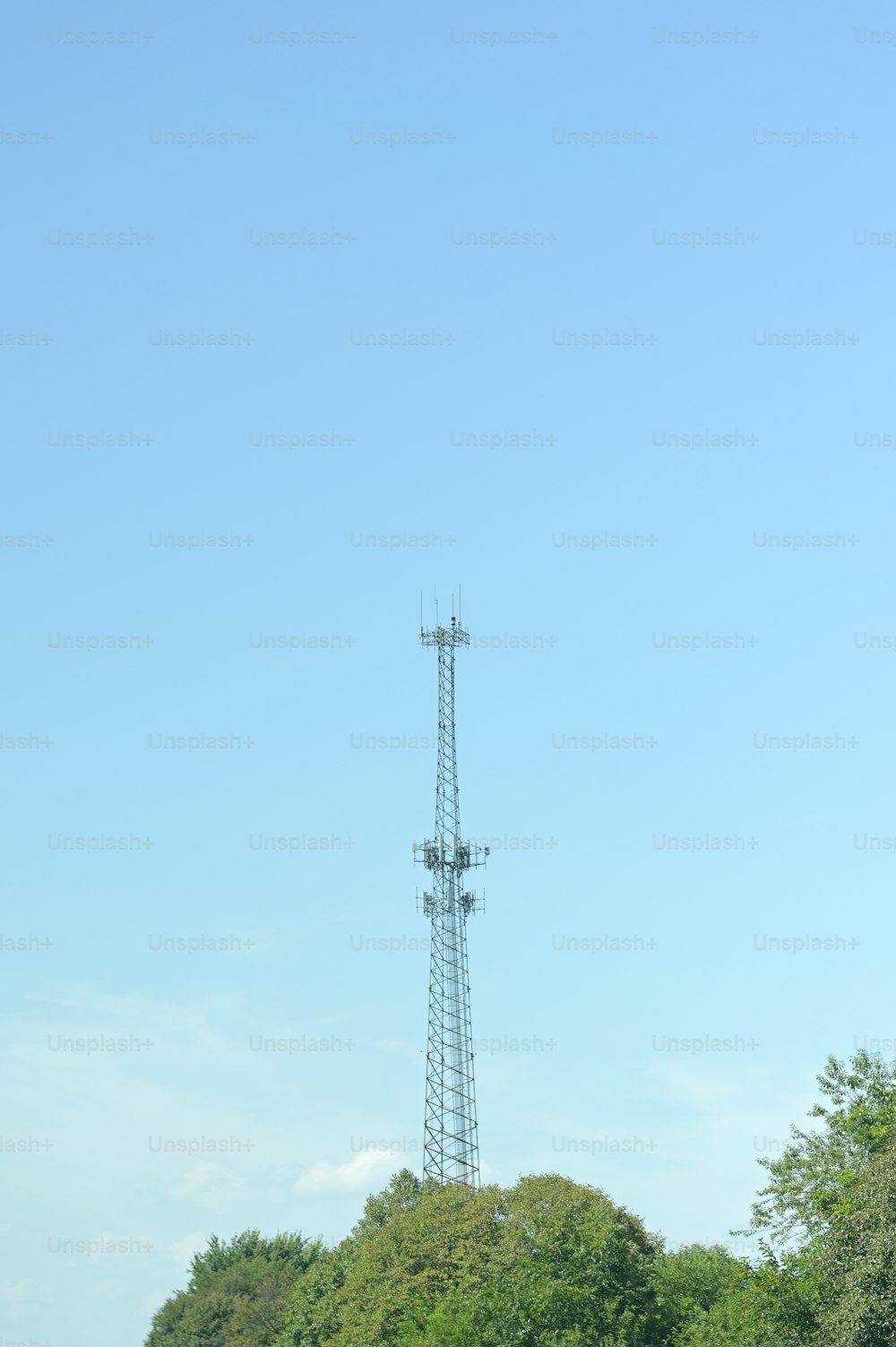 a tall tower sitting above a lush green forest