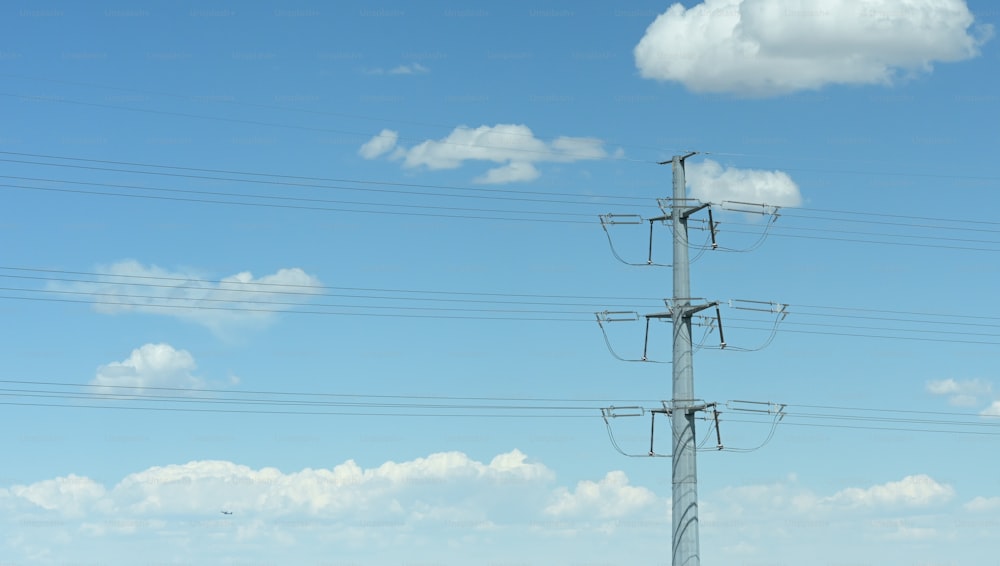 a telephone pole with multiple wires and a sky background