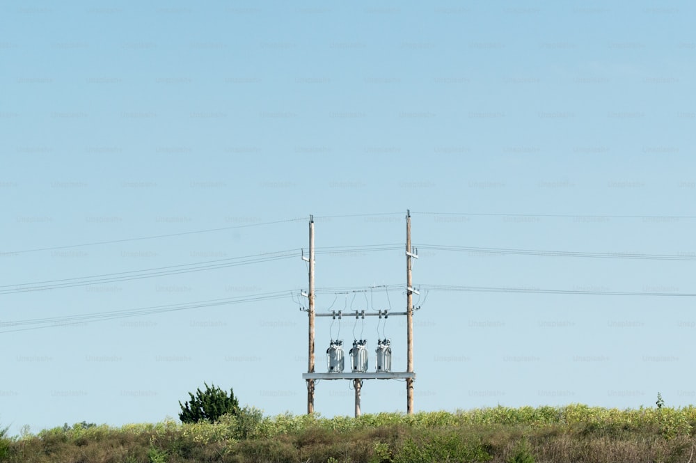 a telephone pole with three cell phones on top of it