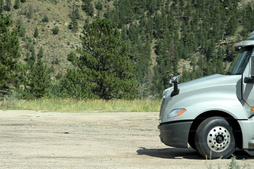 a semi truck parked on a dirt road