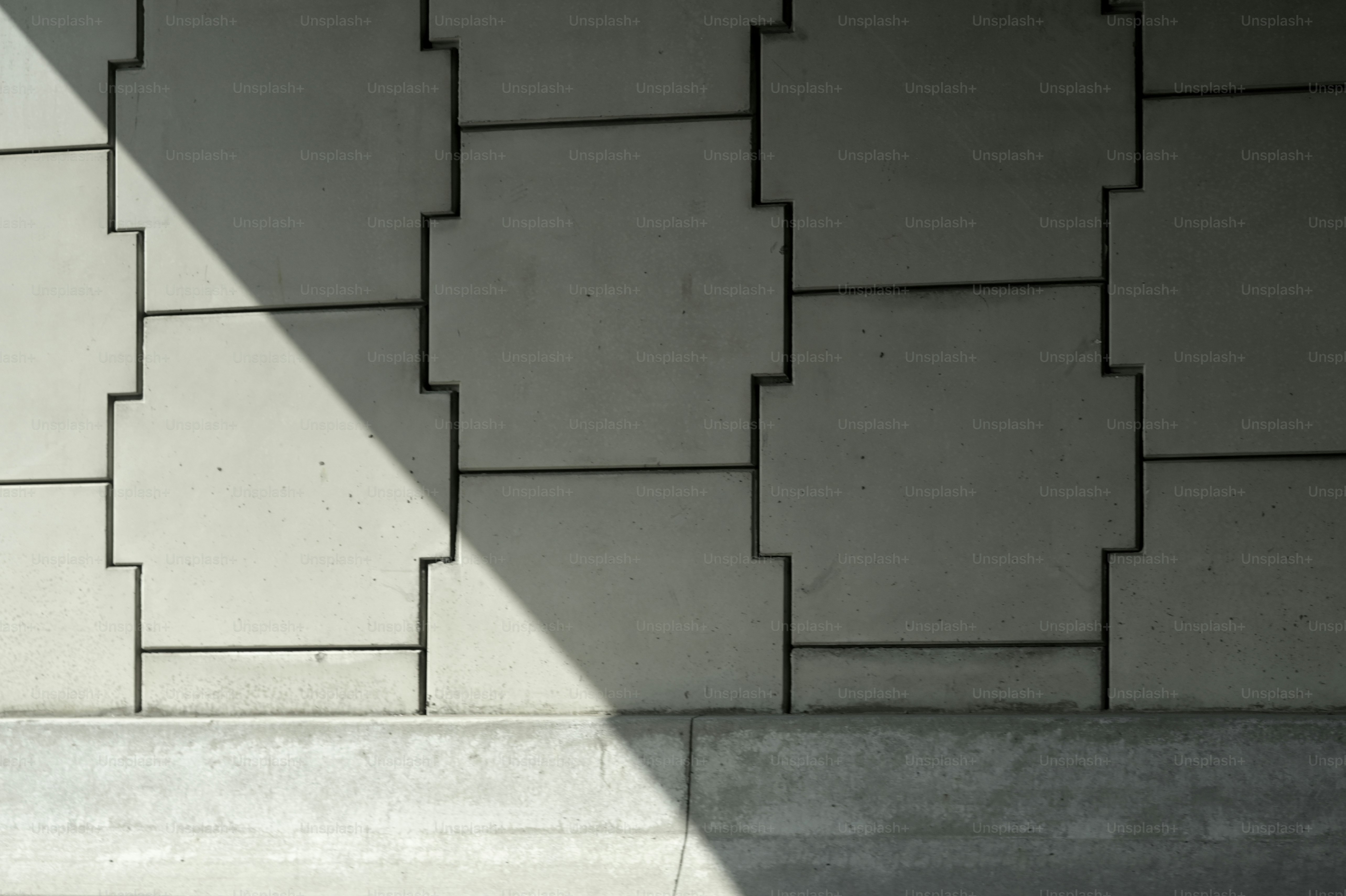 a person sitting on a bench in front of a wall