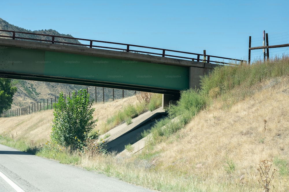 a highway with a bridge over it on a hill