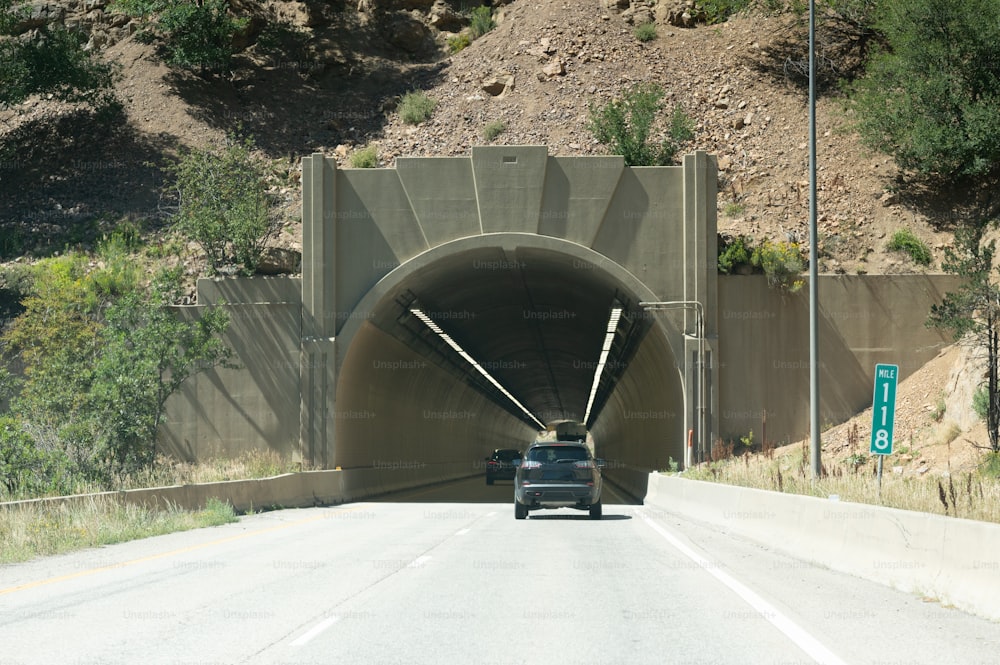 a car driving through a tunnel on a highway