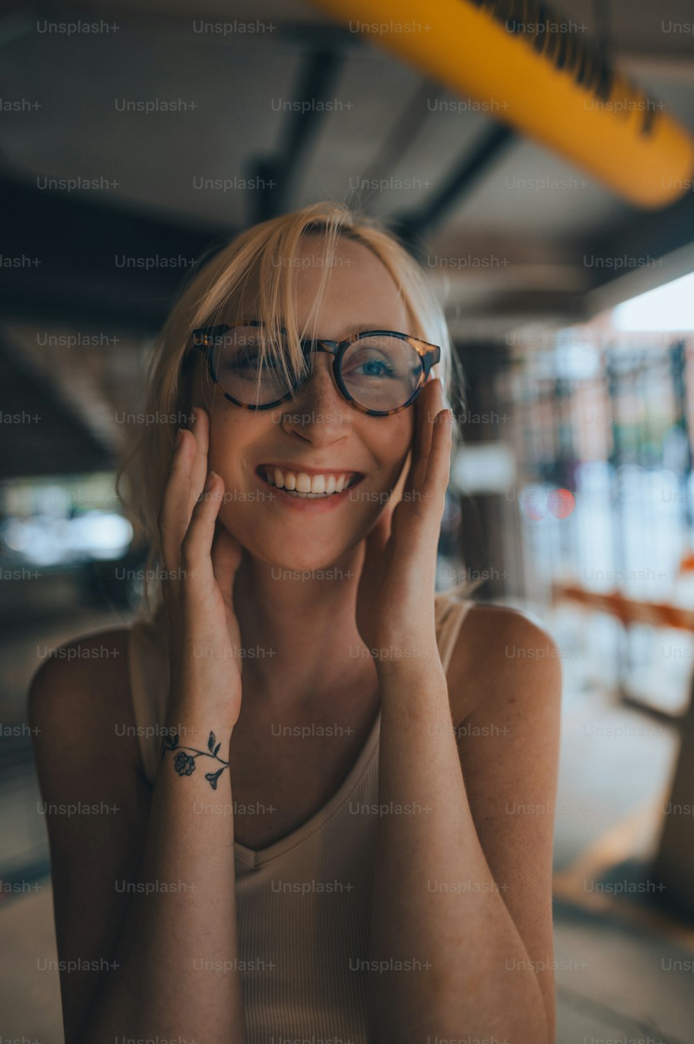 a woman with glasses smiling for the camera