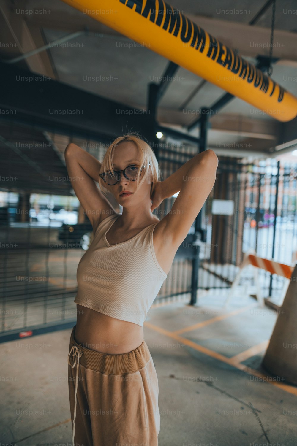 a woman with blonde hair and glasses holding a yellow object