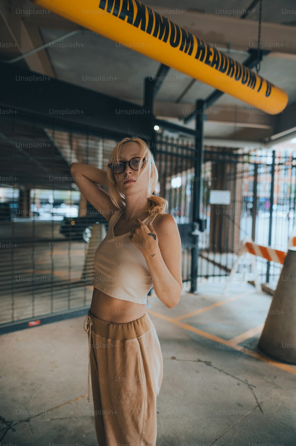 a woman in a white top and tan pants