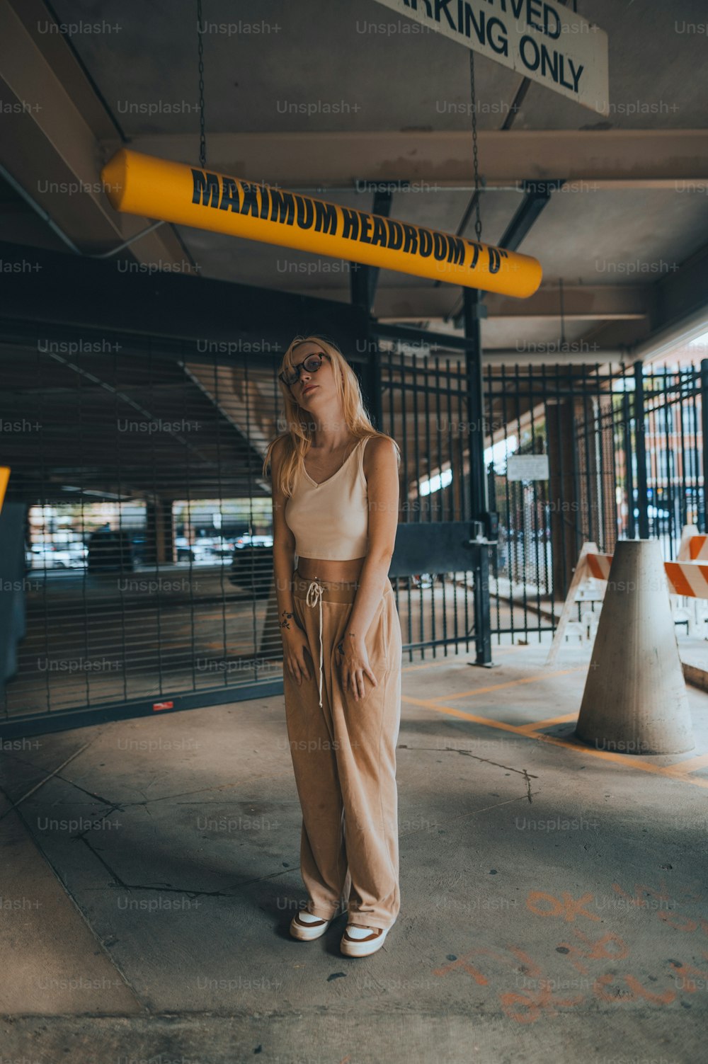 a woman is standing in a parking garage