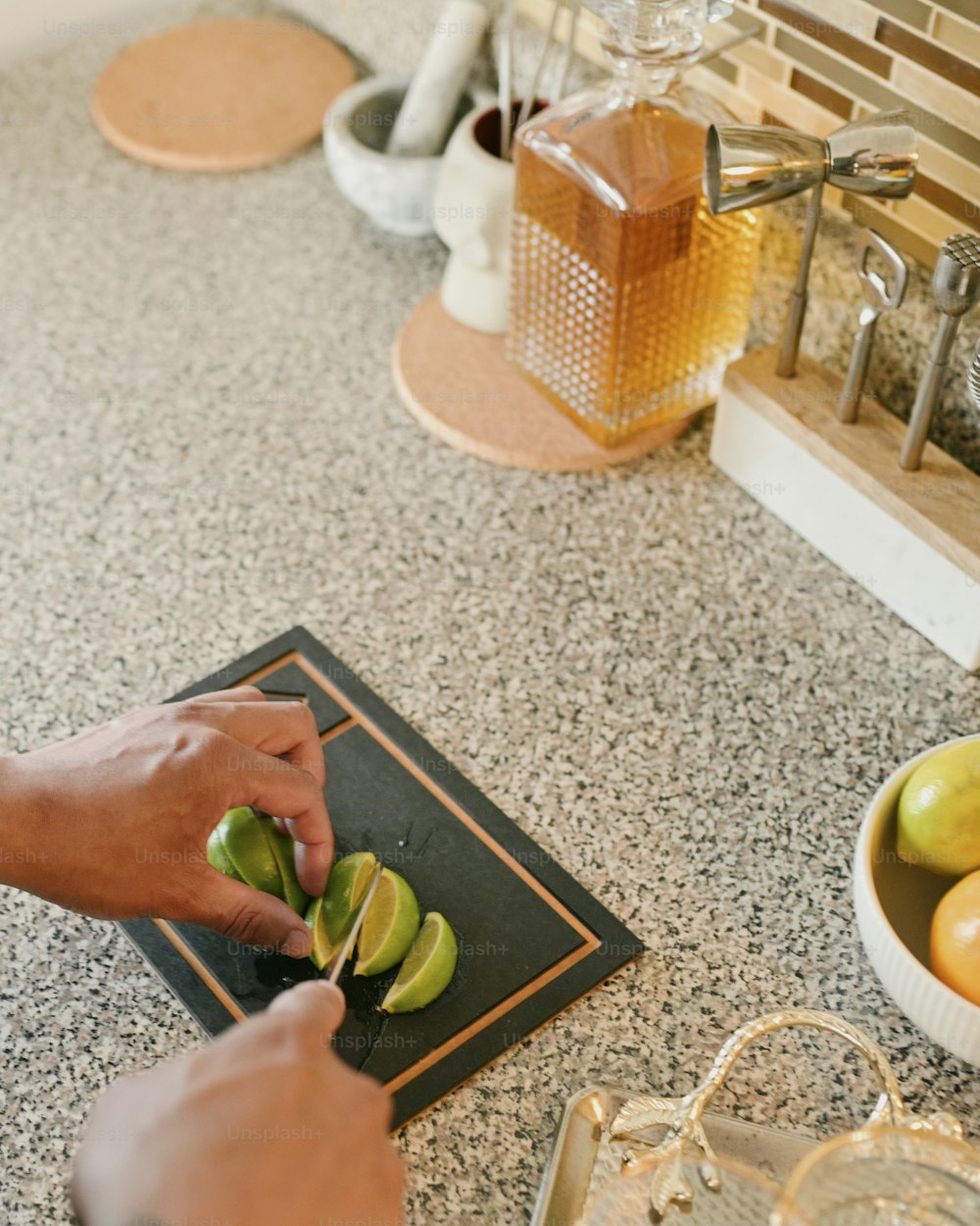 a person cutting limes on a cutting board