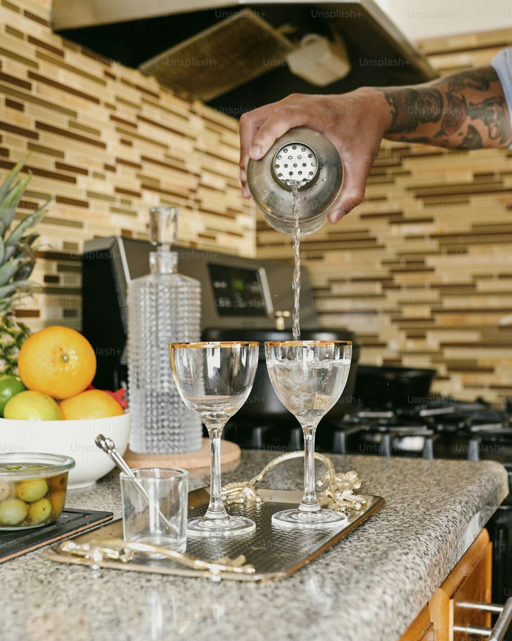 a man pours a glass of wine in a kitchen