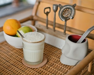 a glass of milk sitting on top of a wooden tray