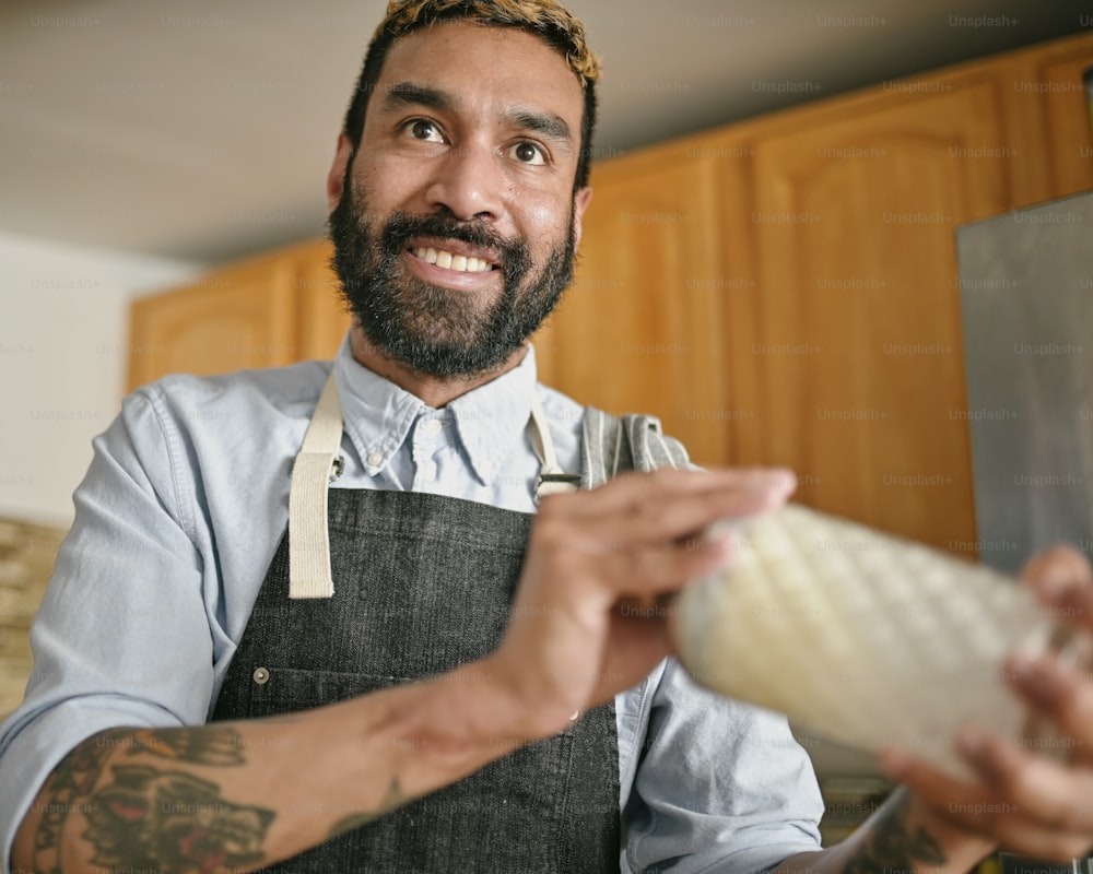 a man in an apron holding a large onion