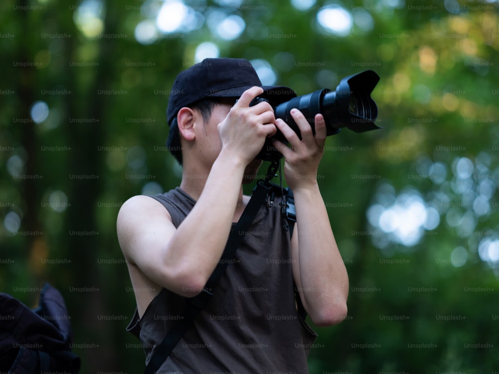 a man holding a camera up to his face