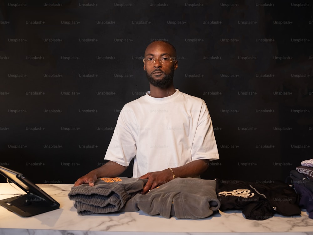 a man sitting at a table with a laptop