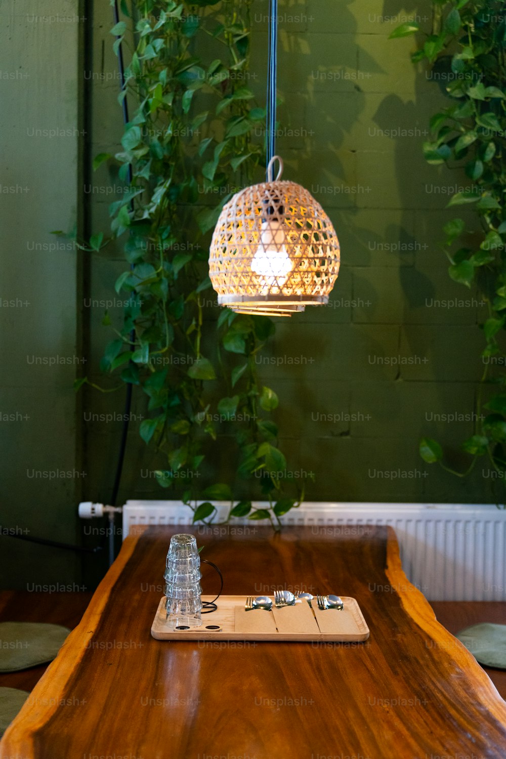 a wooden table with a light hanging from it