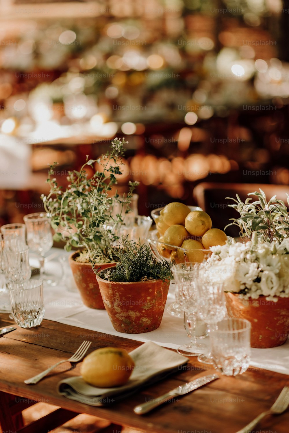 a wooden table topped with pots filled with plants