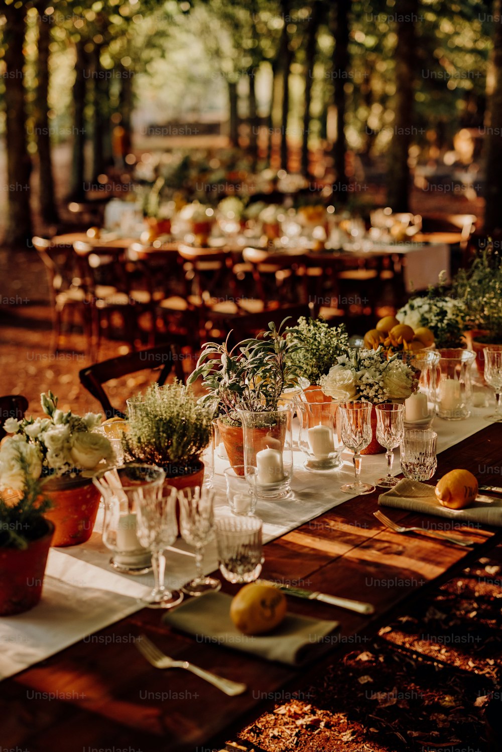 a long table with many glasses and plates on it