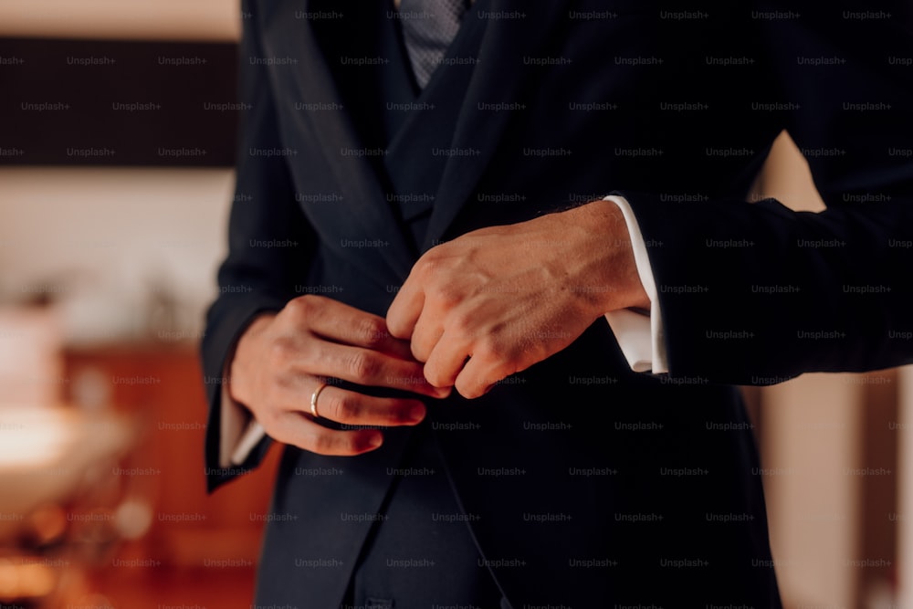 a man in a suit is holding a pen