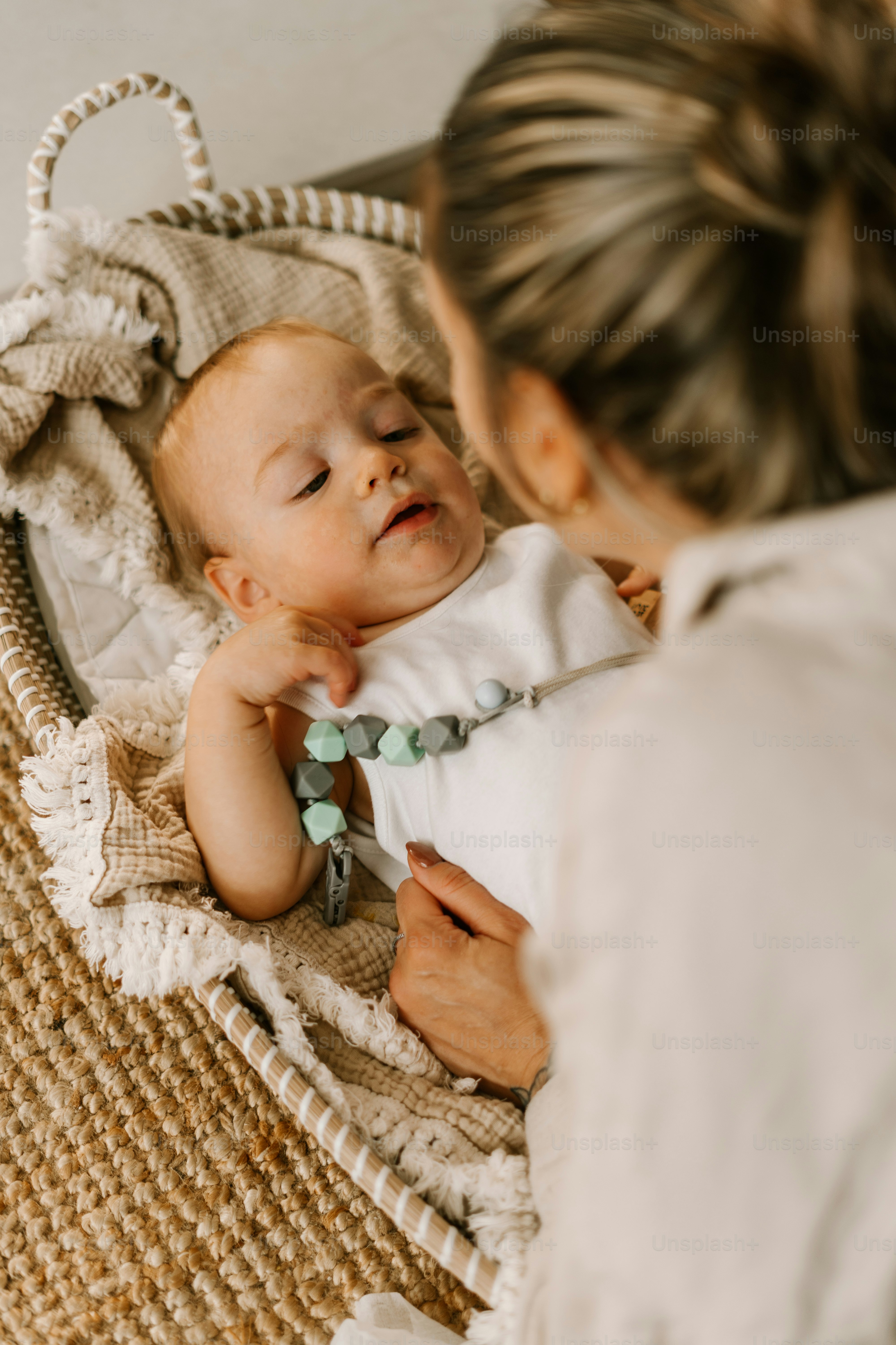 a woman holding a baby in a wicker basket