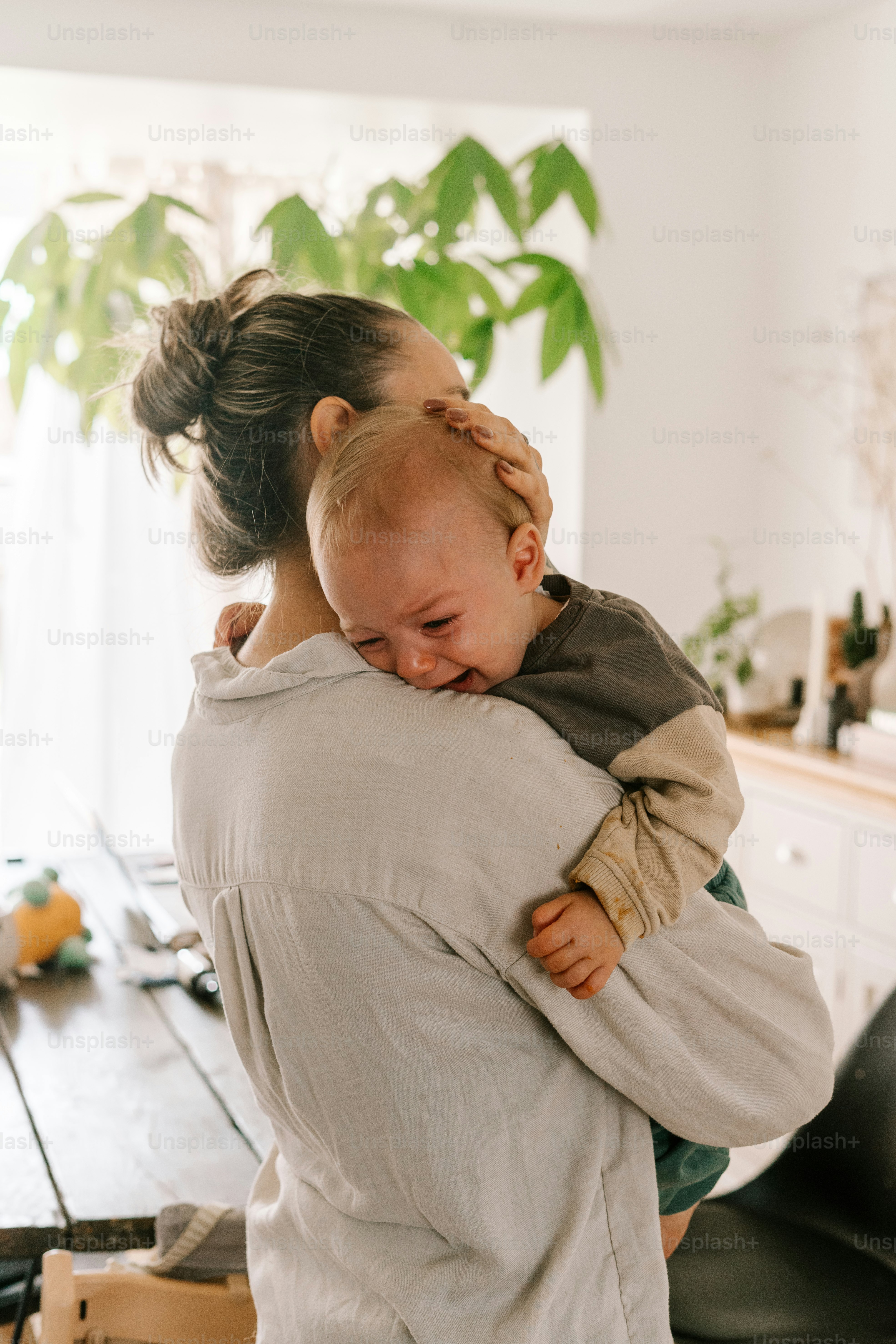 a woman holding a baby in her arms