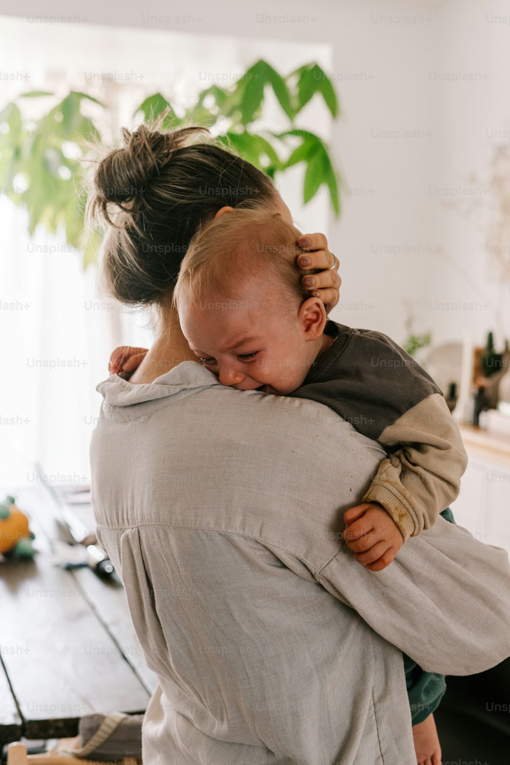 a woman holding a baby in her arms