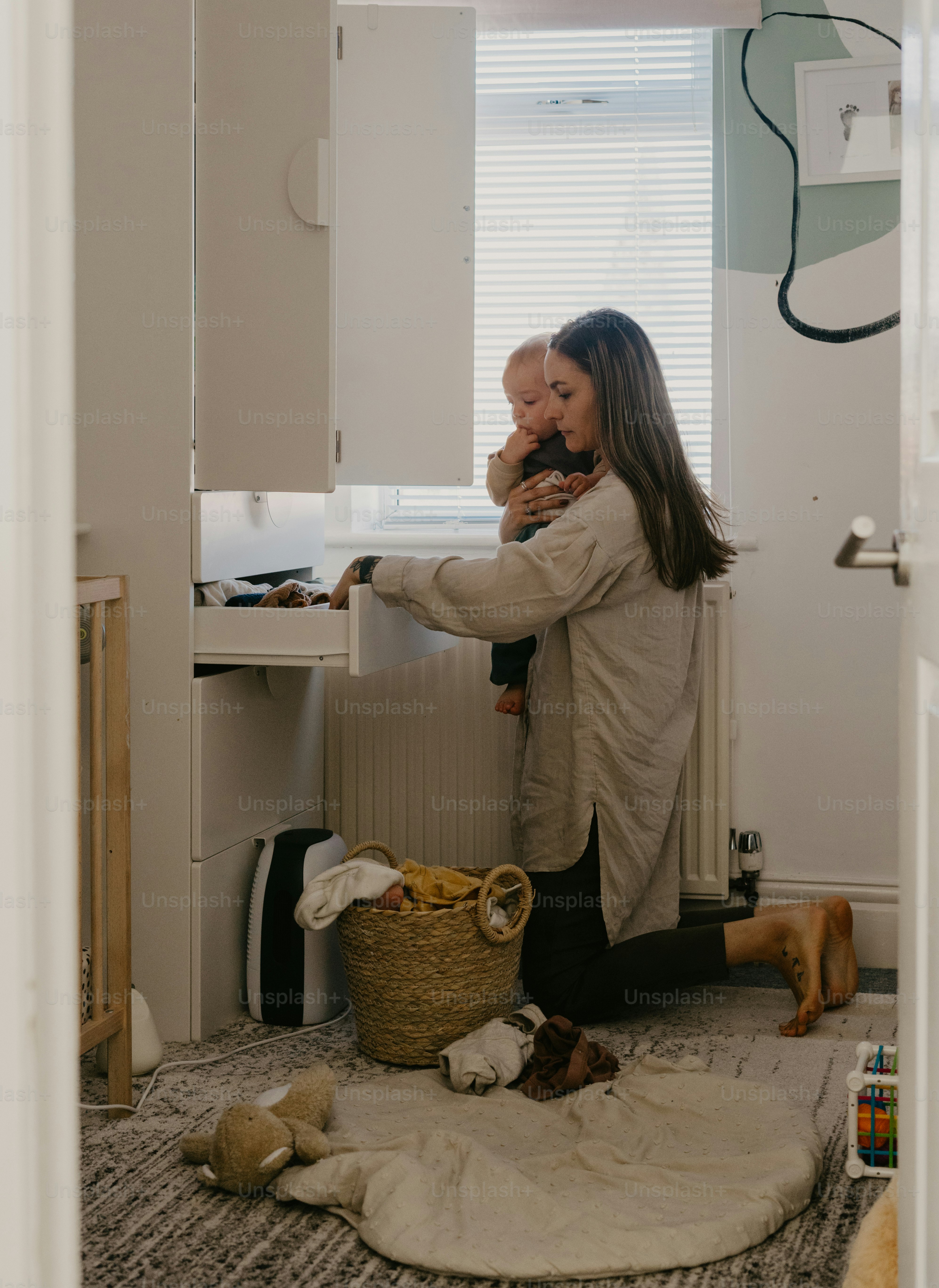 a woman holding a baby in her arms
