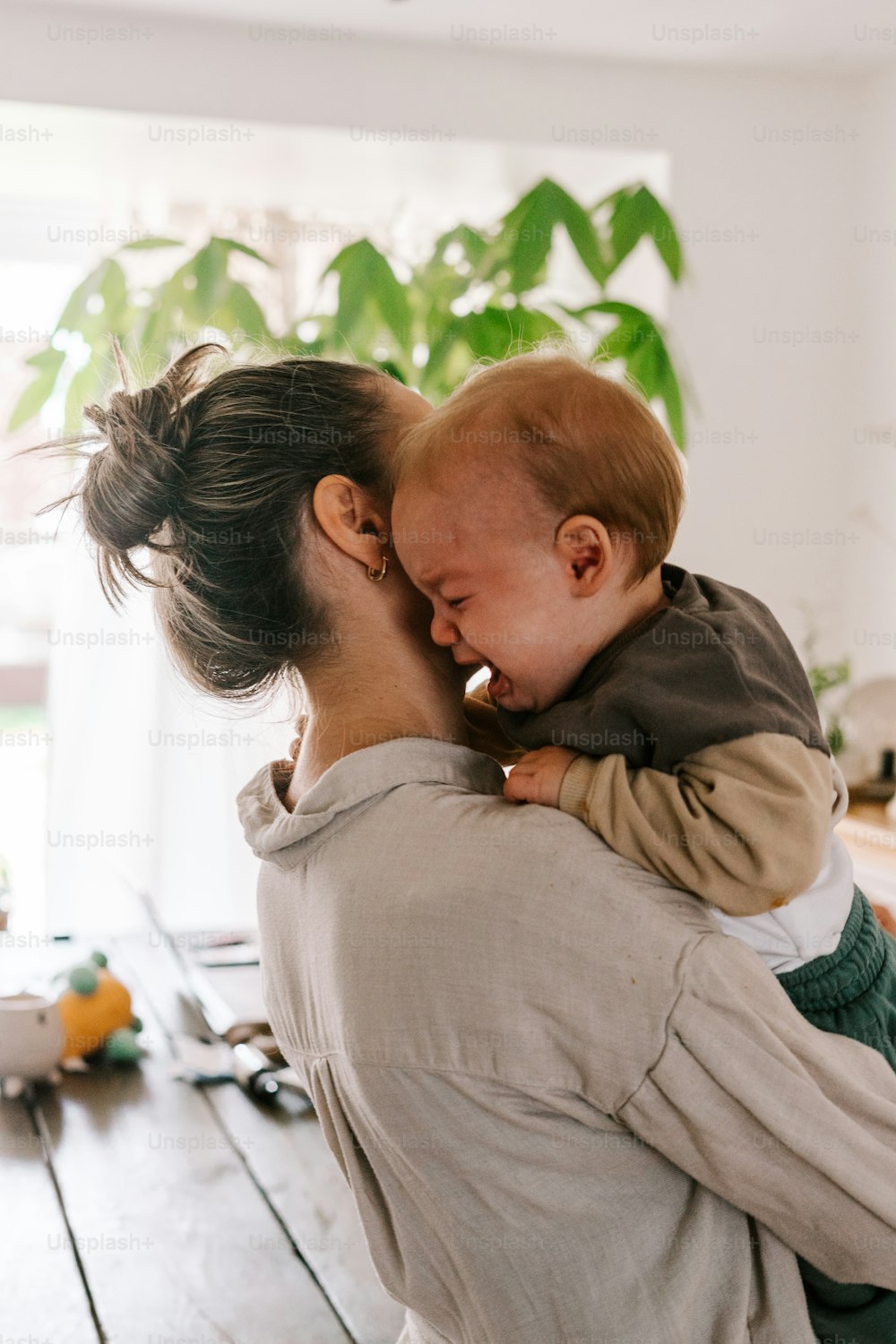 a woman holding a baby in her arms