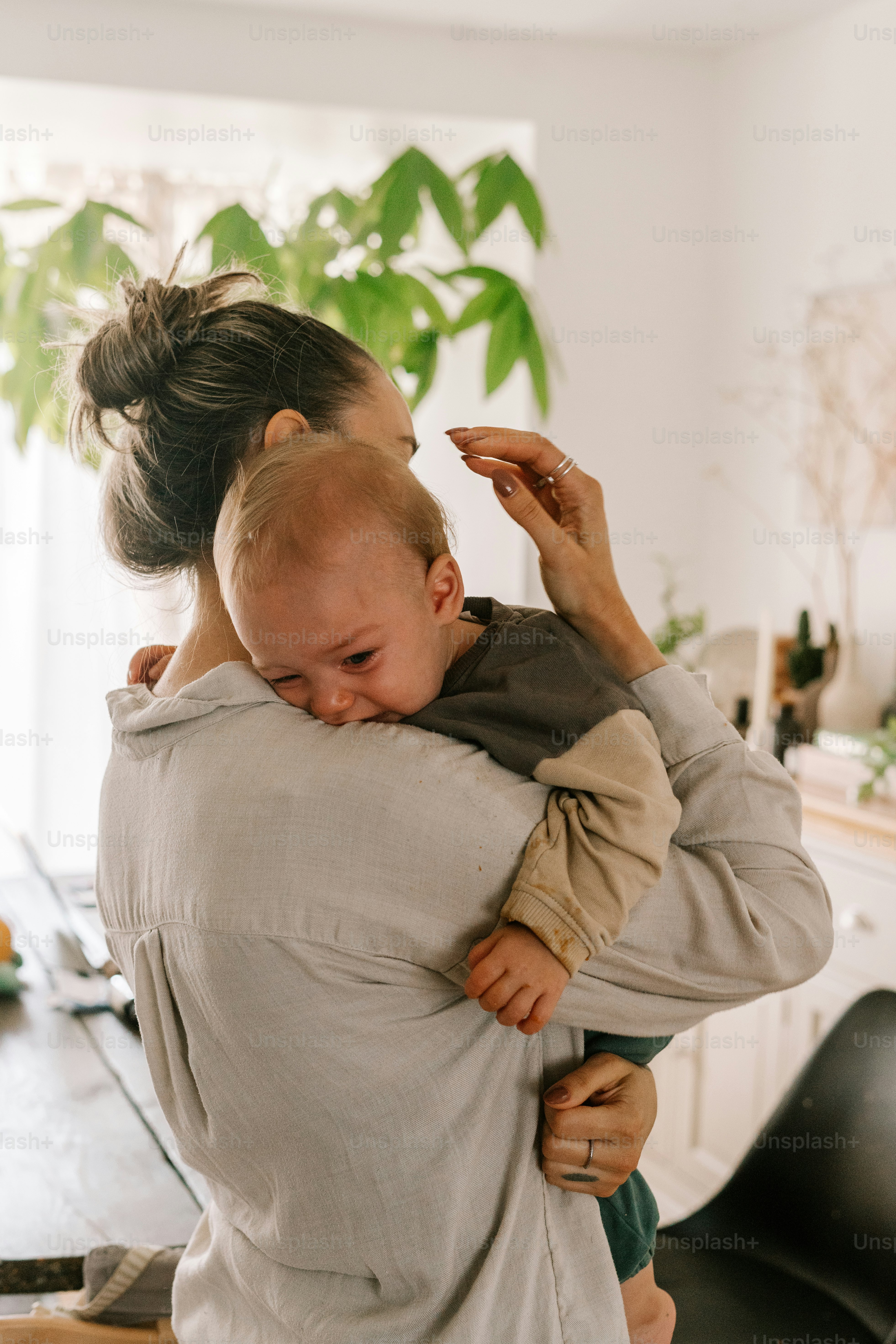 a woman holding a baby in her arms