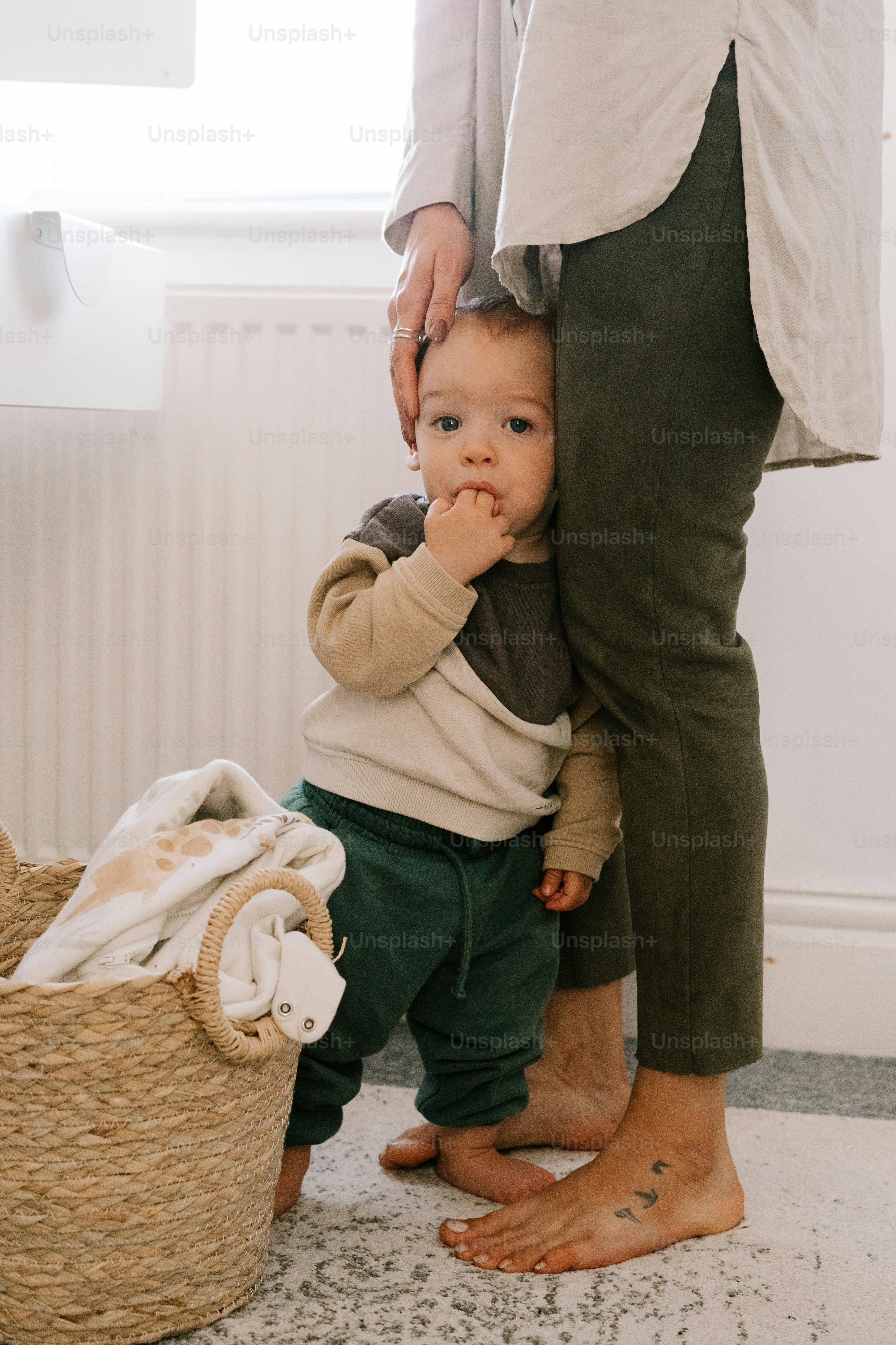 a small child standing next to a woman