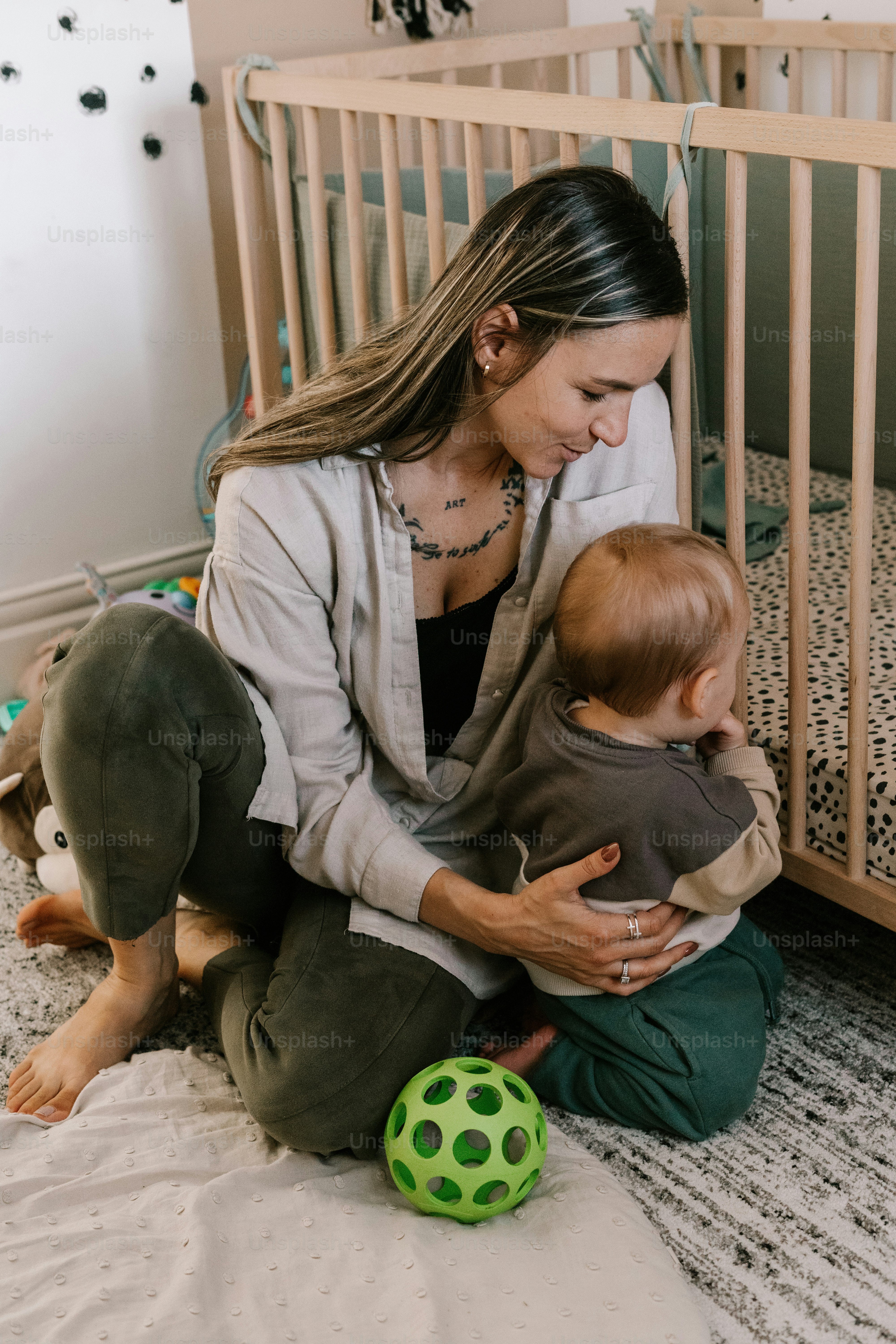 a woman holding a baby in a crib
