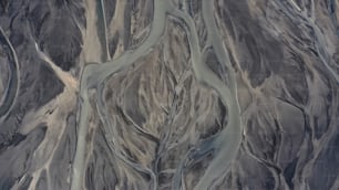 an aerial view of a river running through a mountainous area