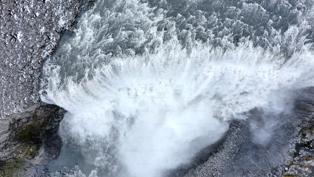 an aerial view of a waterfall with water coming out of it