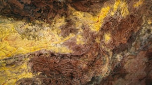 a painting of brown and yellow colors on a wall