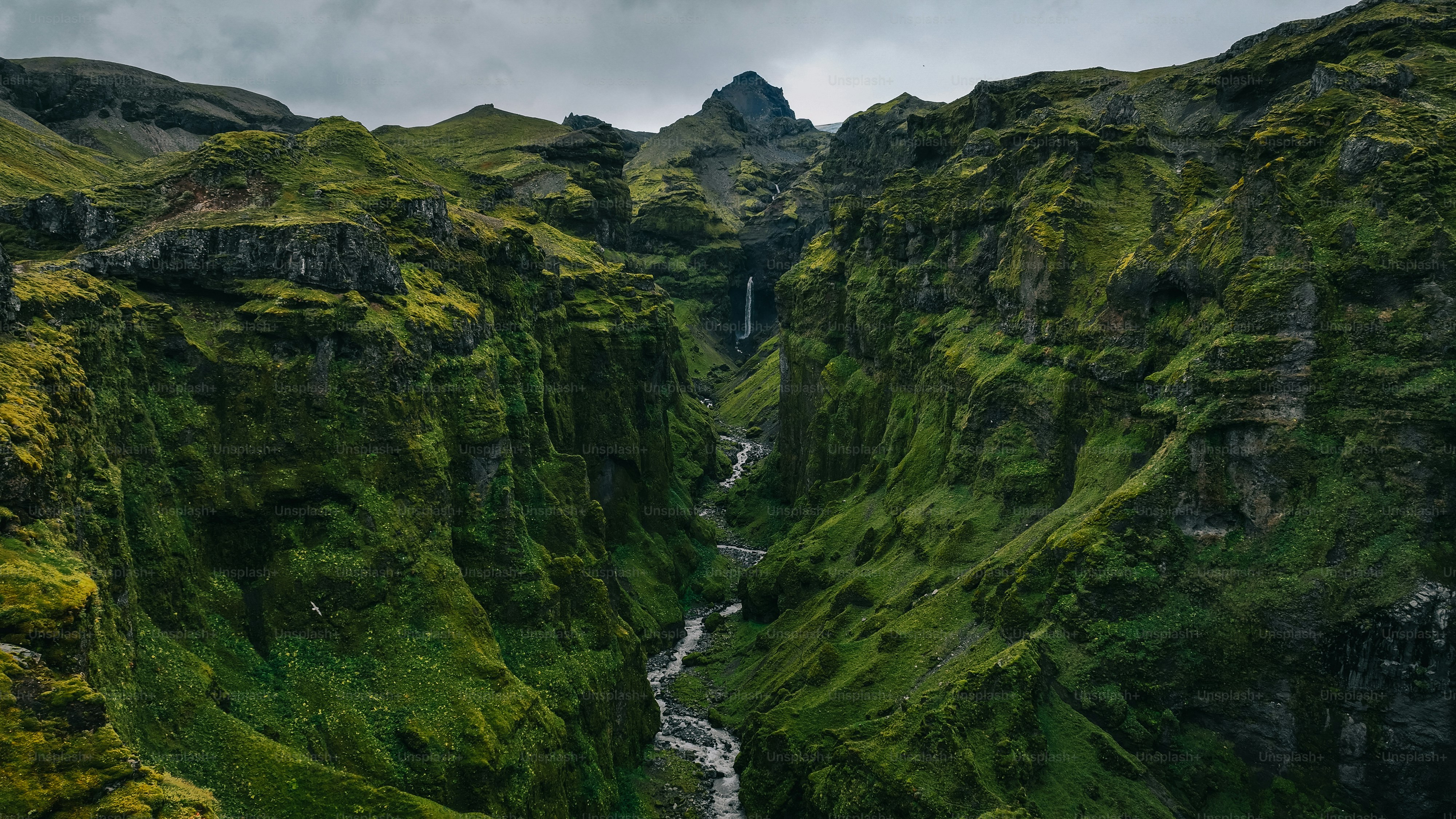 a river running through a lush green valley