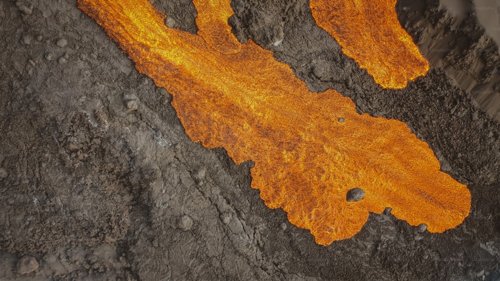 a close up of a piece of wood with orange paint on it