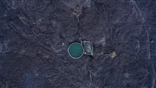 an aerial view of a pond surrounded by dirt