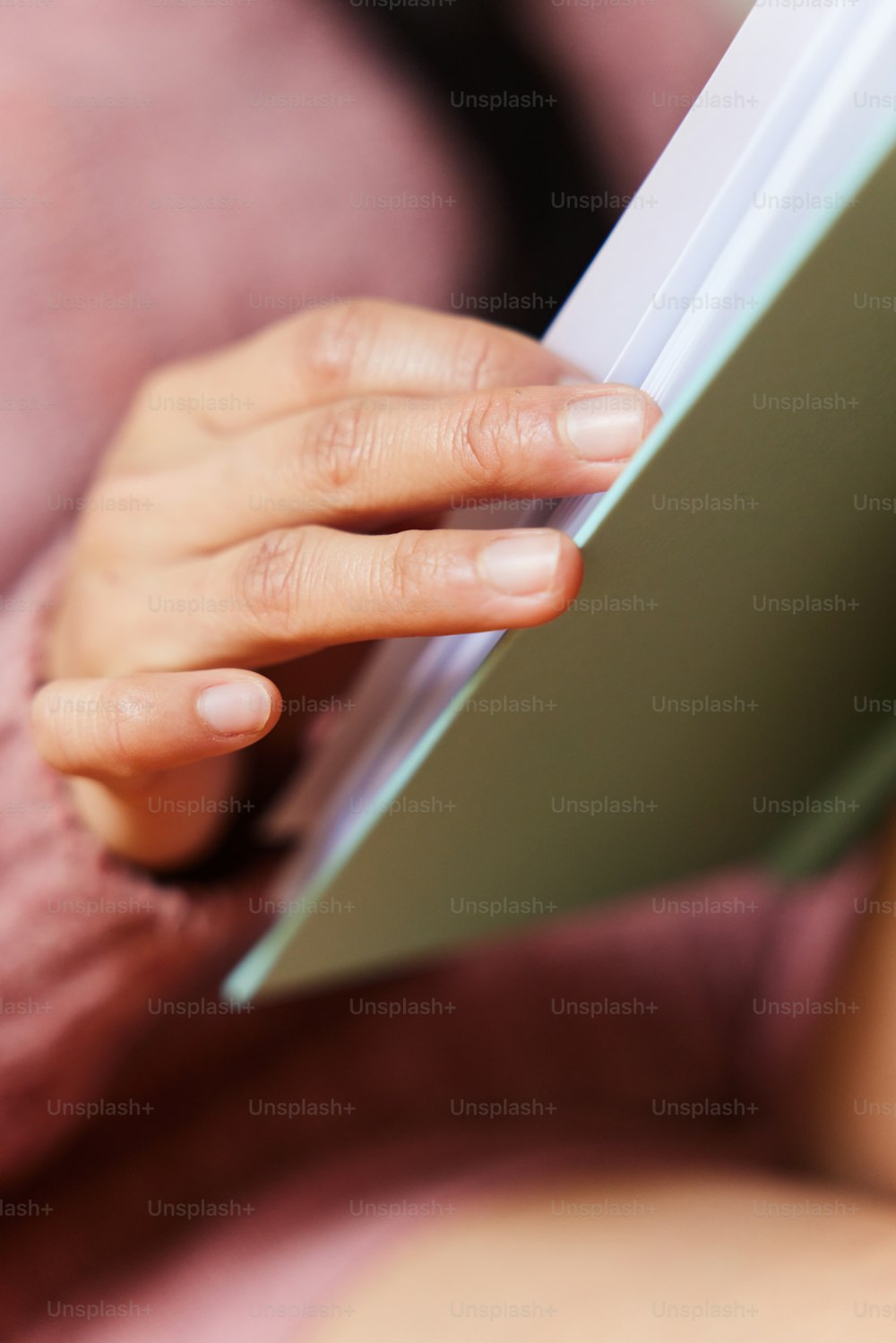a close up of a person holding a book