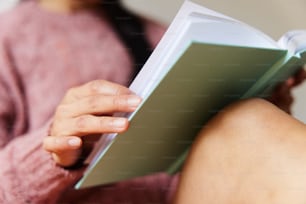 a close up of a person reading a book