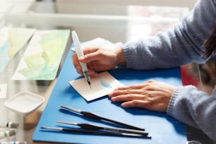 a woman is writing on a piece of paper