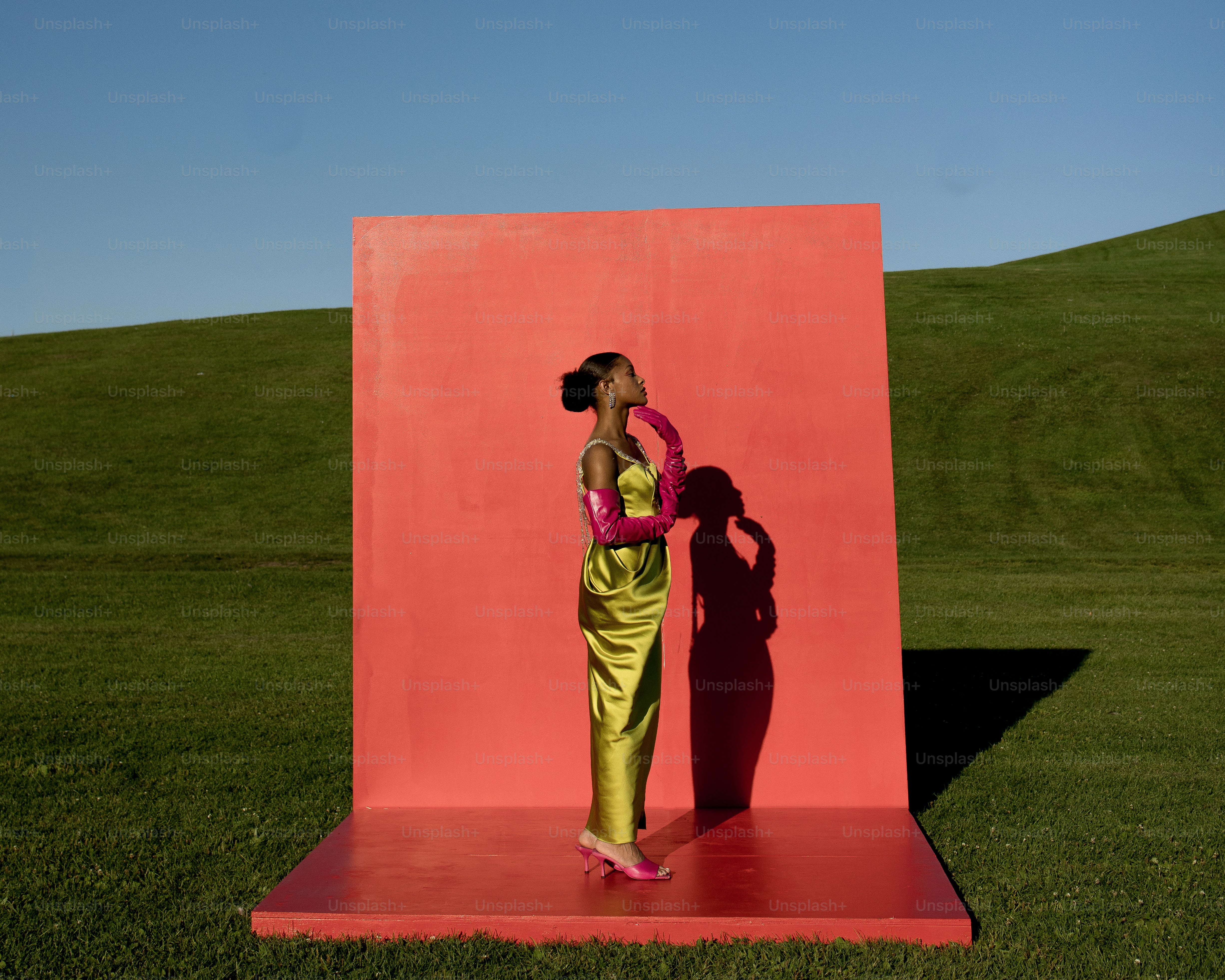 a woman standing in front of a red wall