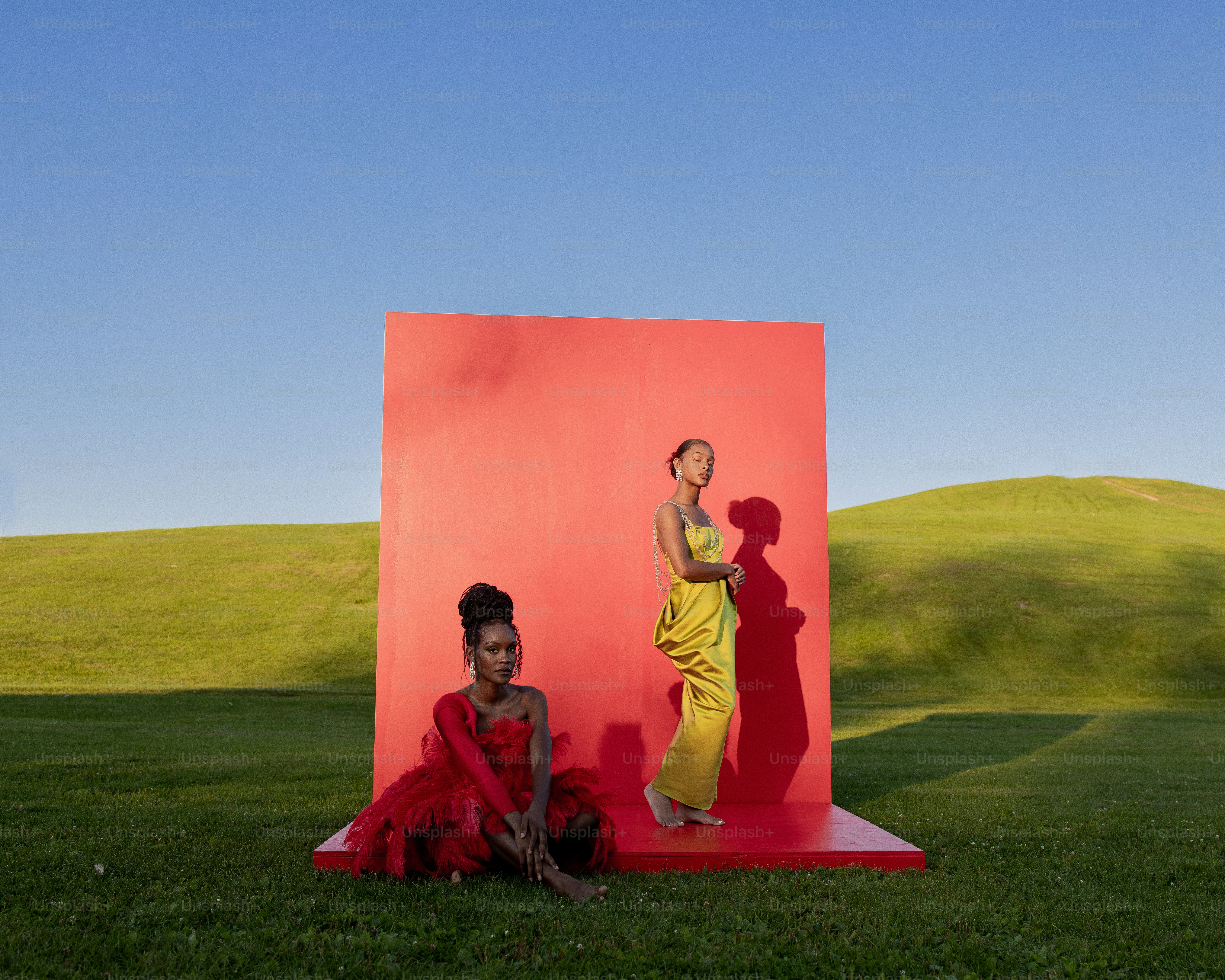a couple of women standing next to each other on a field