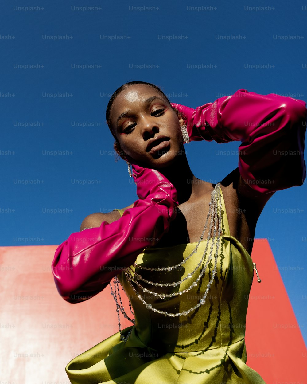 a woman in a pink top and yellow skirt