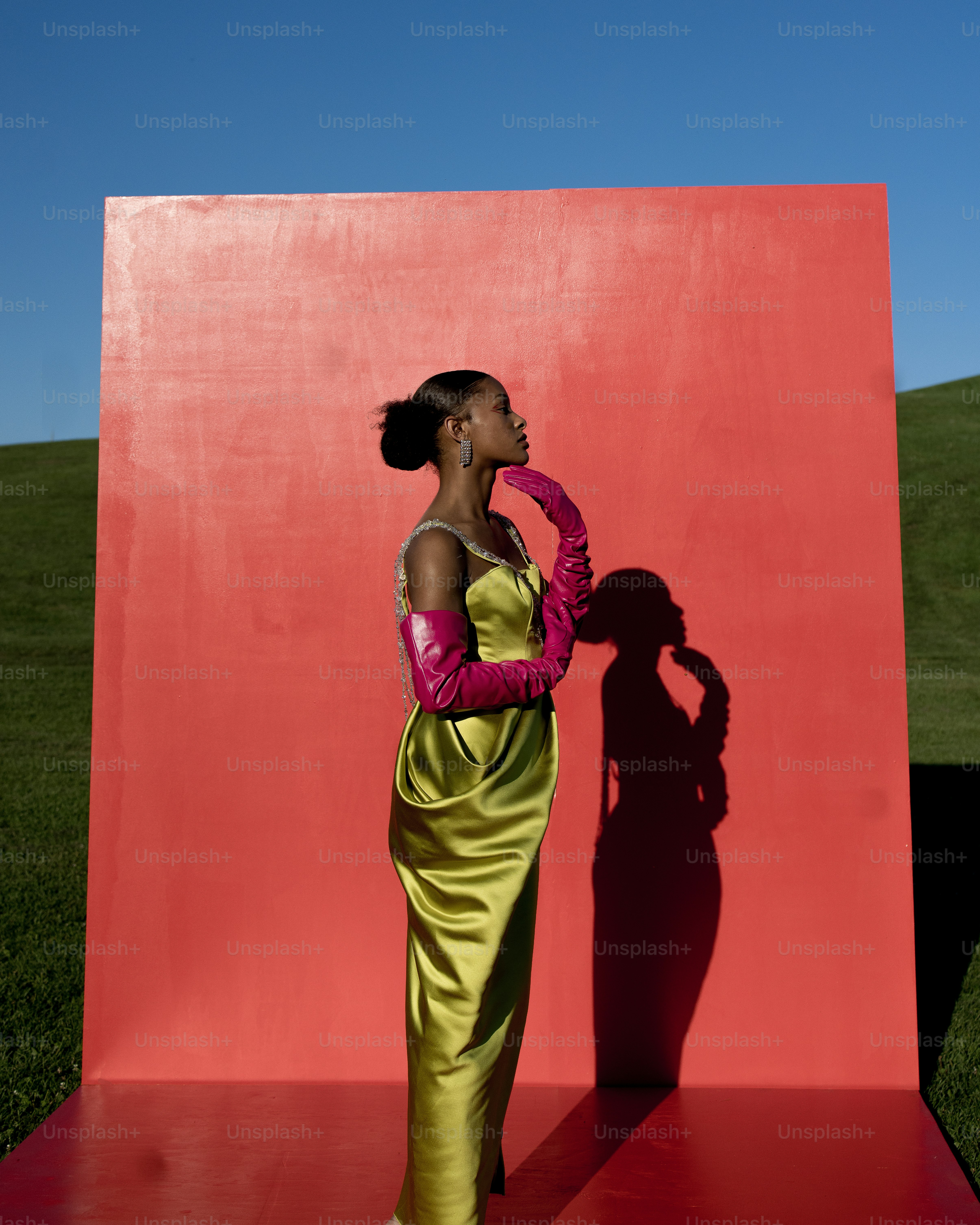 a woman standing in front of a red wall