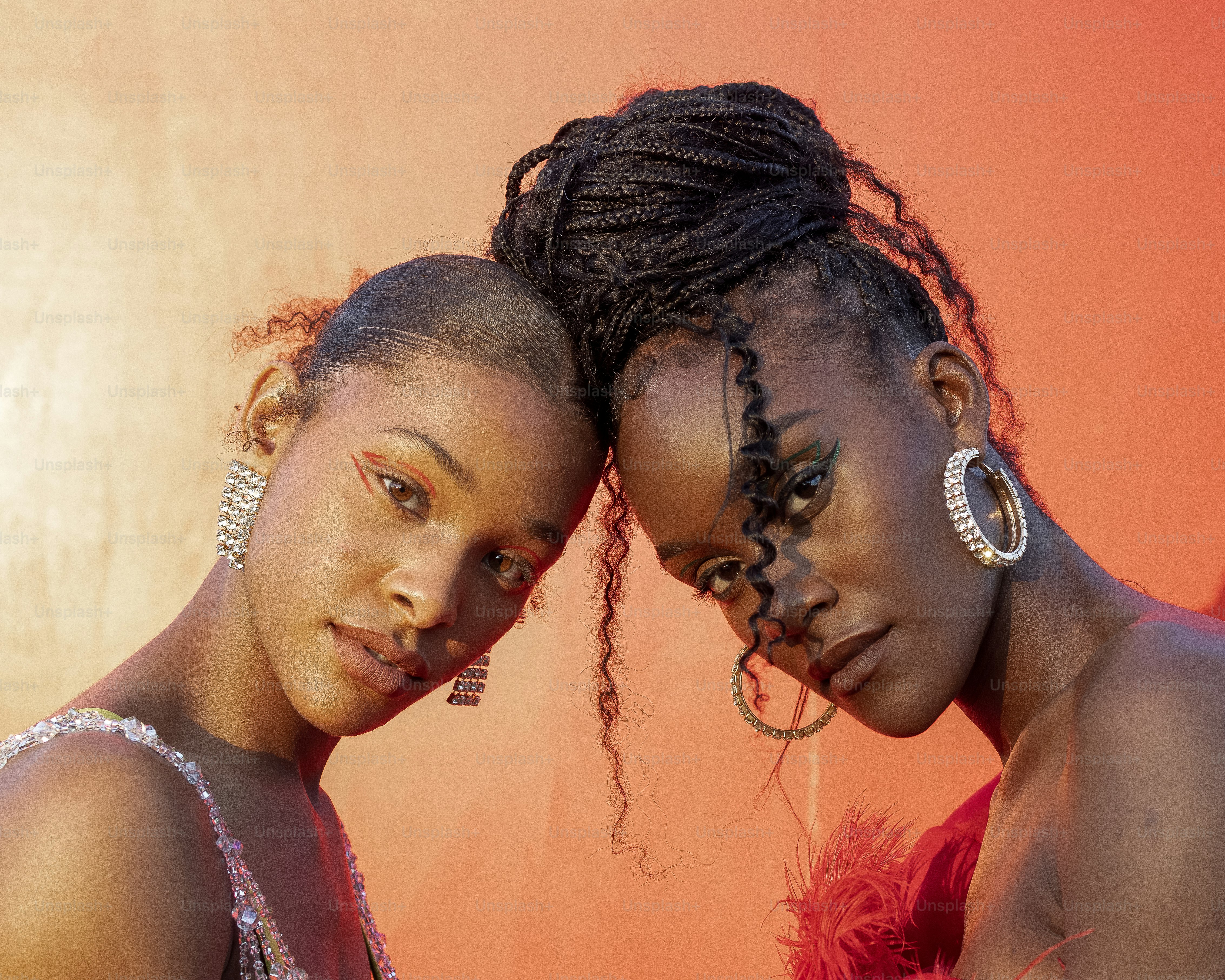two beautiful young women standing next to each other