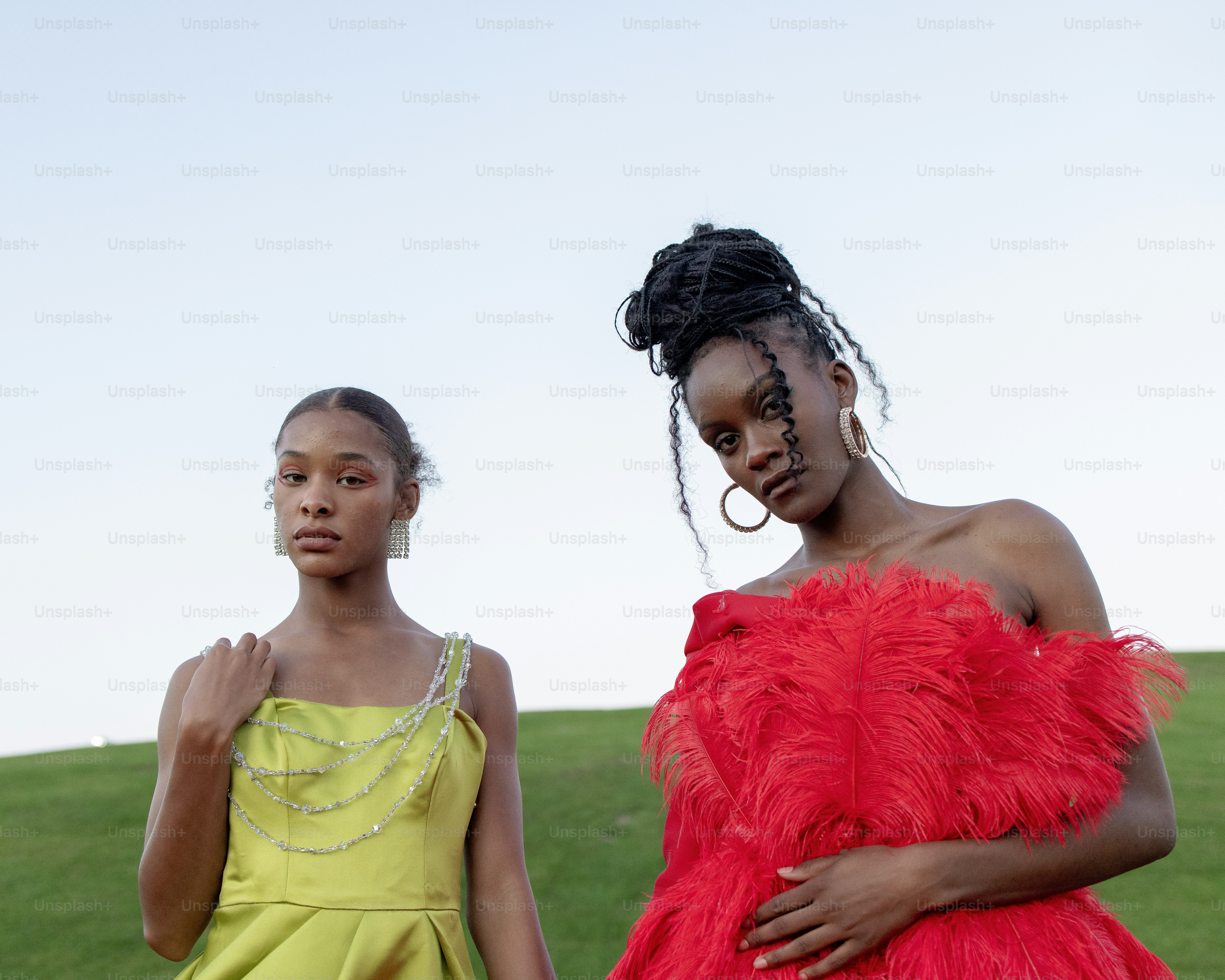 two women standing next to each other in dresses